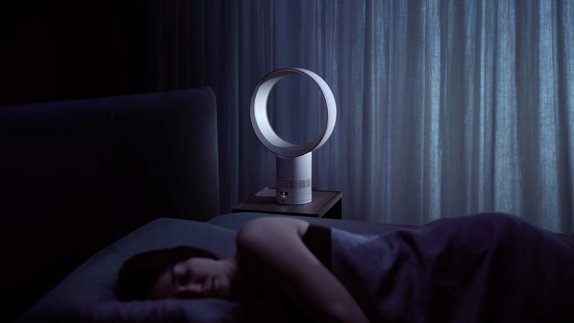 A woman sleeping next to the Dyson Cool CF1 bladeless fan