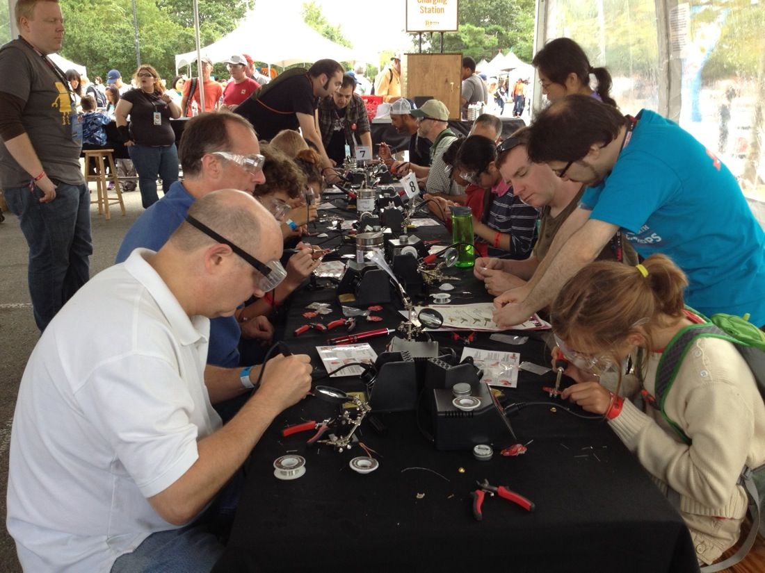 People of all ages learn how to solder at World Maker Faire in New York on Sept. 21, 2013.