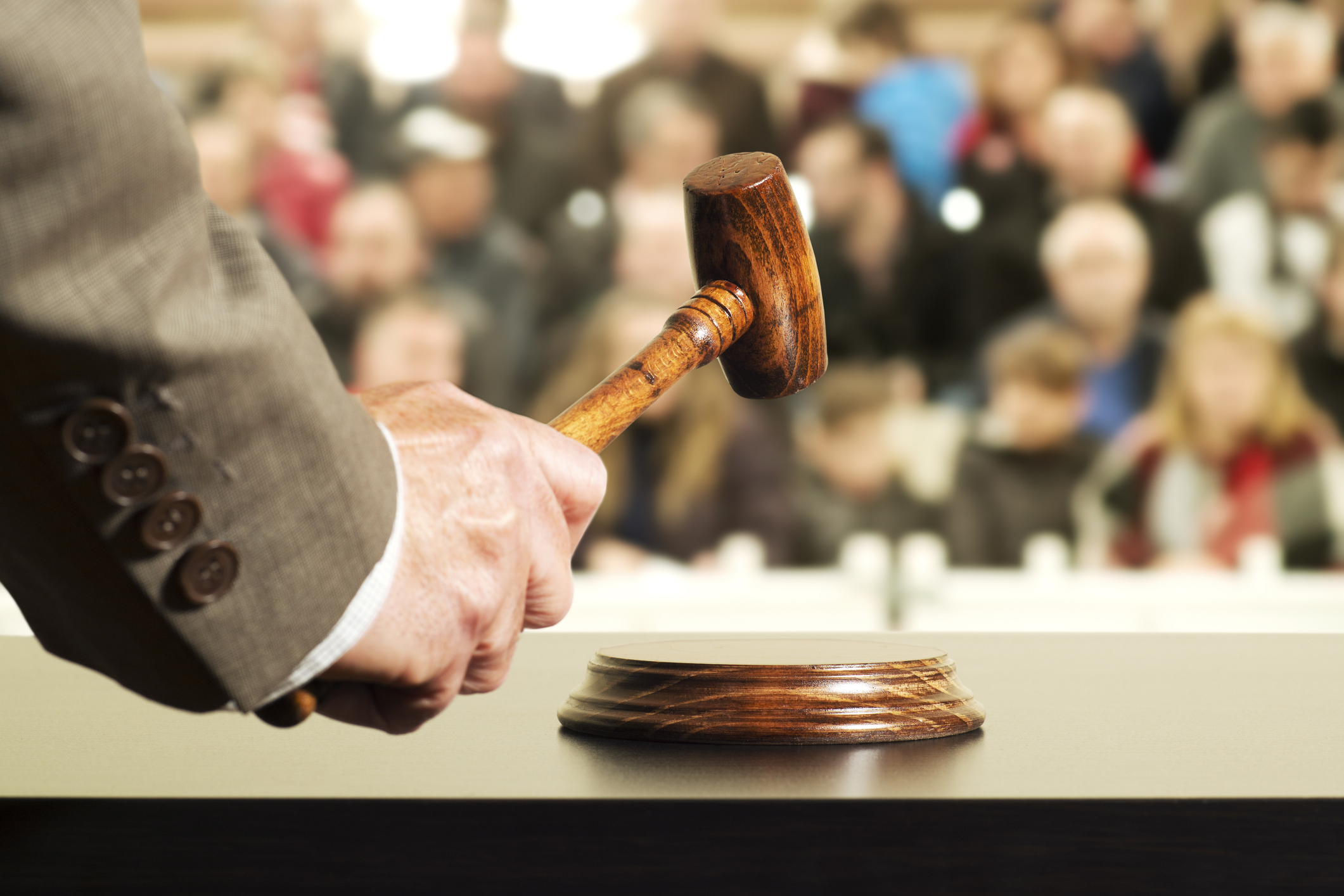 Auctioneer banging hammer to indicate an item has been sold