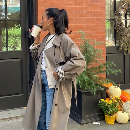 Lauren Tappan wearing a trench coat and jeans 