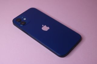 The iPhone 12 in blue on a pink background