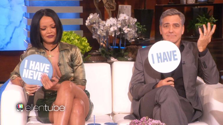 George Clooney holding up a sign that reads "I have"