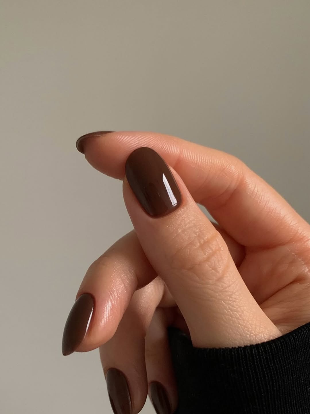 An almond-shaped chocolate manicure by Georgia Rae
