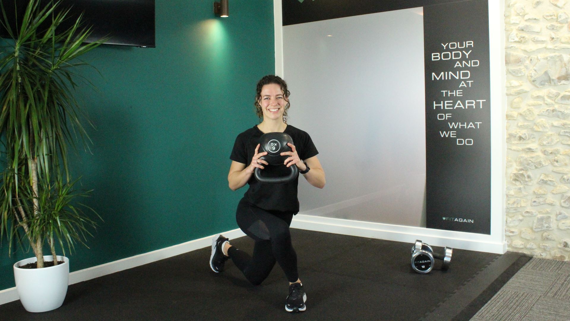 Personal trainer Alanah Bray demonstrates a curtsy squat