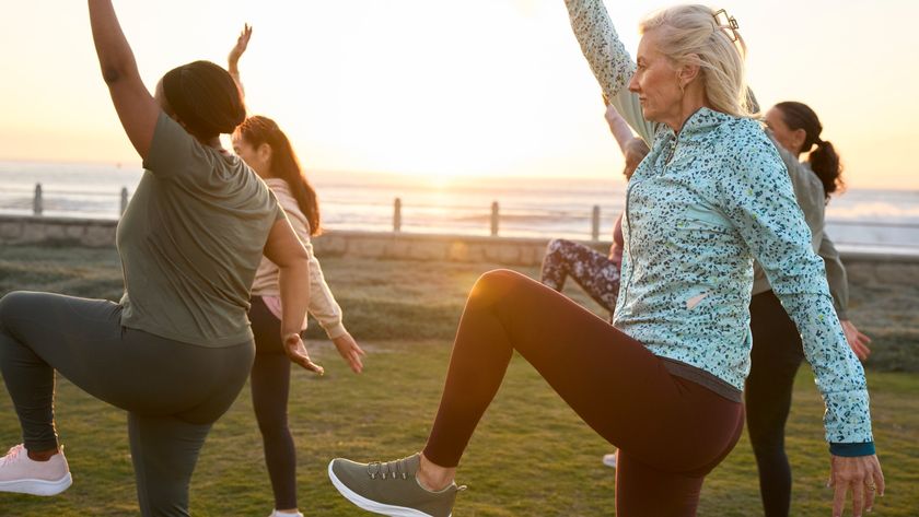 A group of mature exercisers balancing outside during a workout