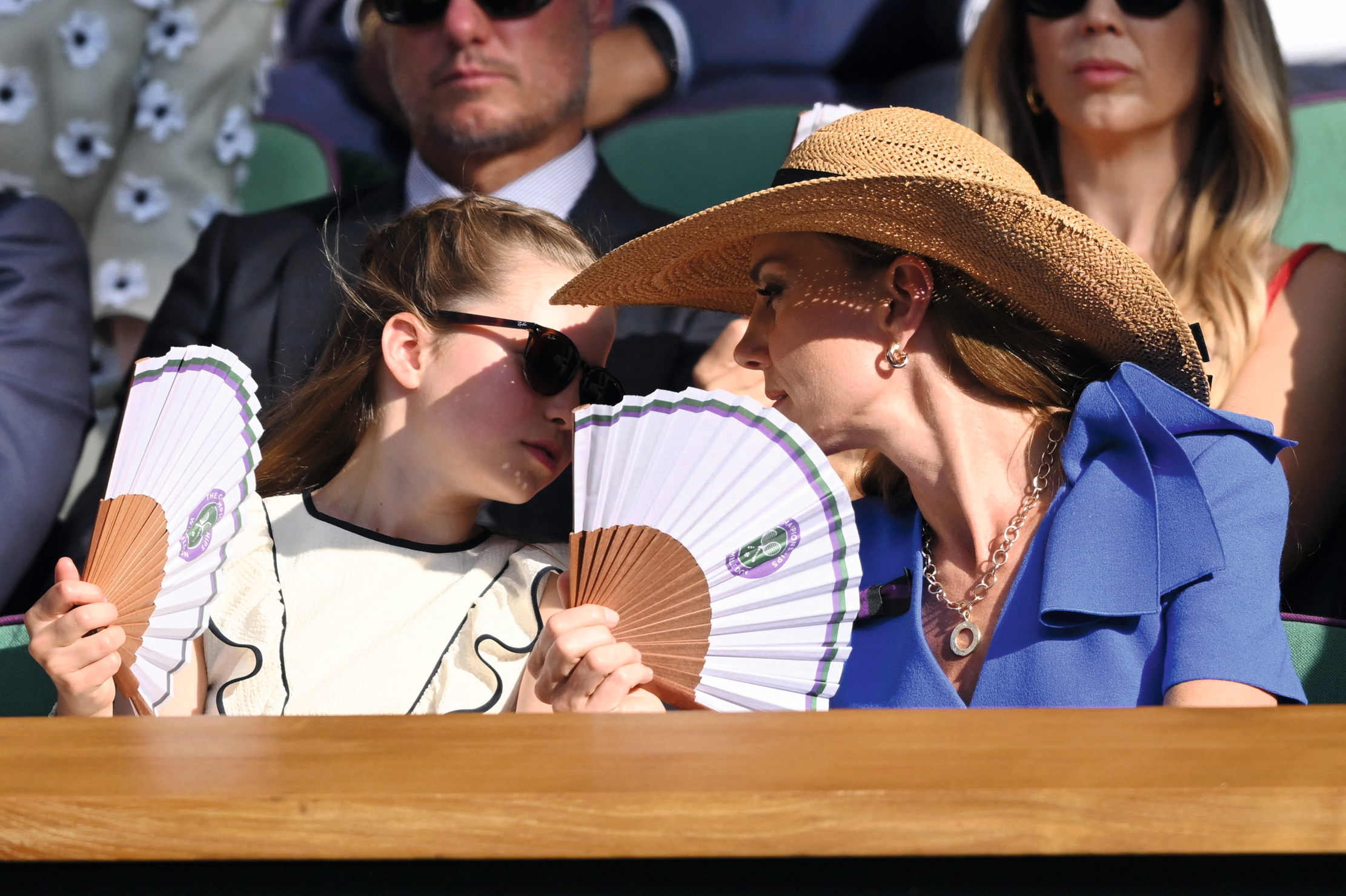 The Princess of Wales and her daughter fan themselves in the Royal Box at Wimbledon
