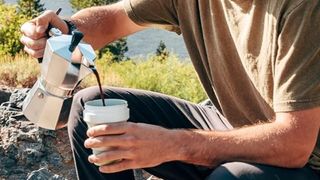 Man pouring coffee into Stojo 12oz Folding Mug