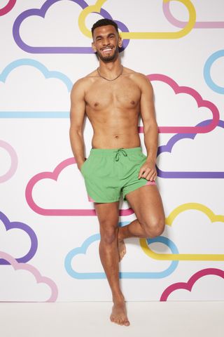 Kai Fagan poses in front of a cloudy background for Love Island 2023