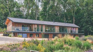 self build with timber cladding on hillside