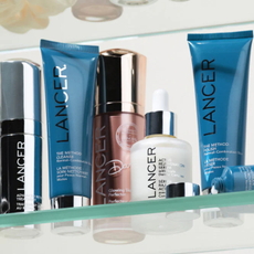 A variety of Lancer Skincare products on a glass shelf.