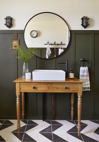 small bathroom in industrial style with round mirror and recycled vanity by BC Designs