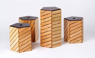 A collection of pentagonal seating in five of the different hardwoods