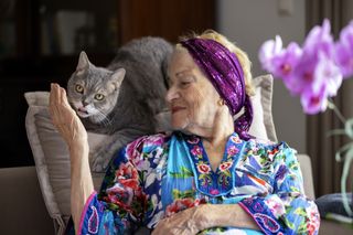 A woman strokes her cat