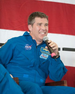 At Ellington Field's Hangar 276, NASA astronaut Steve Bowen, STS-132 mission specialist, speaks to a large crowd of visitors at the crew return ceremony for space shuttle Atlantis' May 2010 mission.