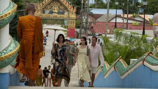 Victoria, Tim and Piper arriving at the meditation centre and being welcomes by monks in orange robes