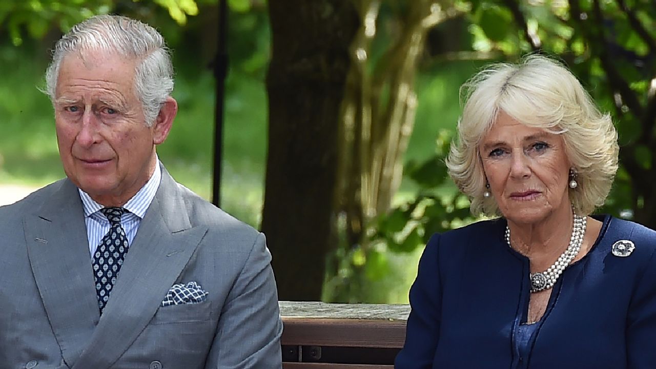 King Charles and Queen Camilla look sad as they sit on a bench at the dedication service for the National Memorial to British Victims of Overseas Terrorism at the National Memorial Arboretum on May 17, 2018