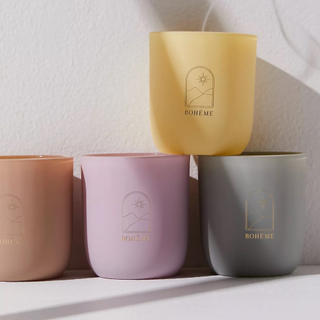 Collection of Wanderlust travel candles in lavender, clay, yellow, and grey