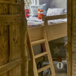 child's room with wooden loft bed and toys