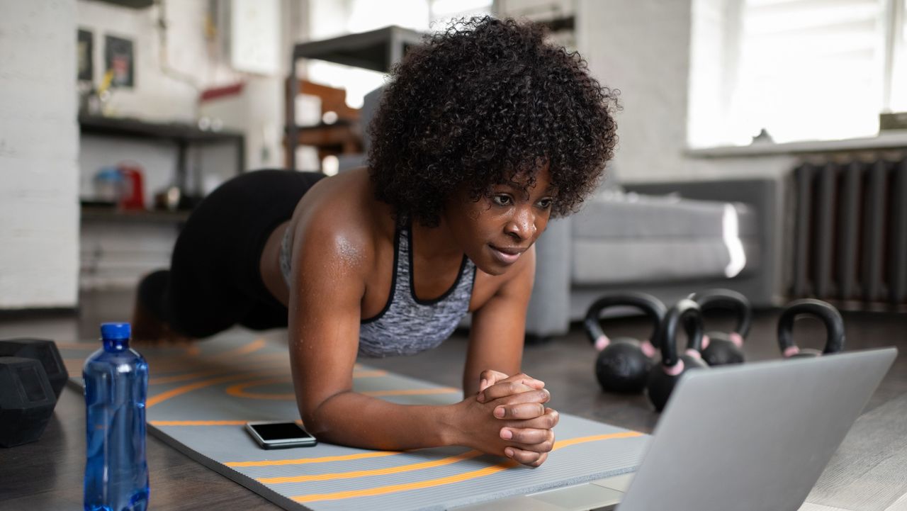 Woman doing plank position during home workout