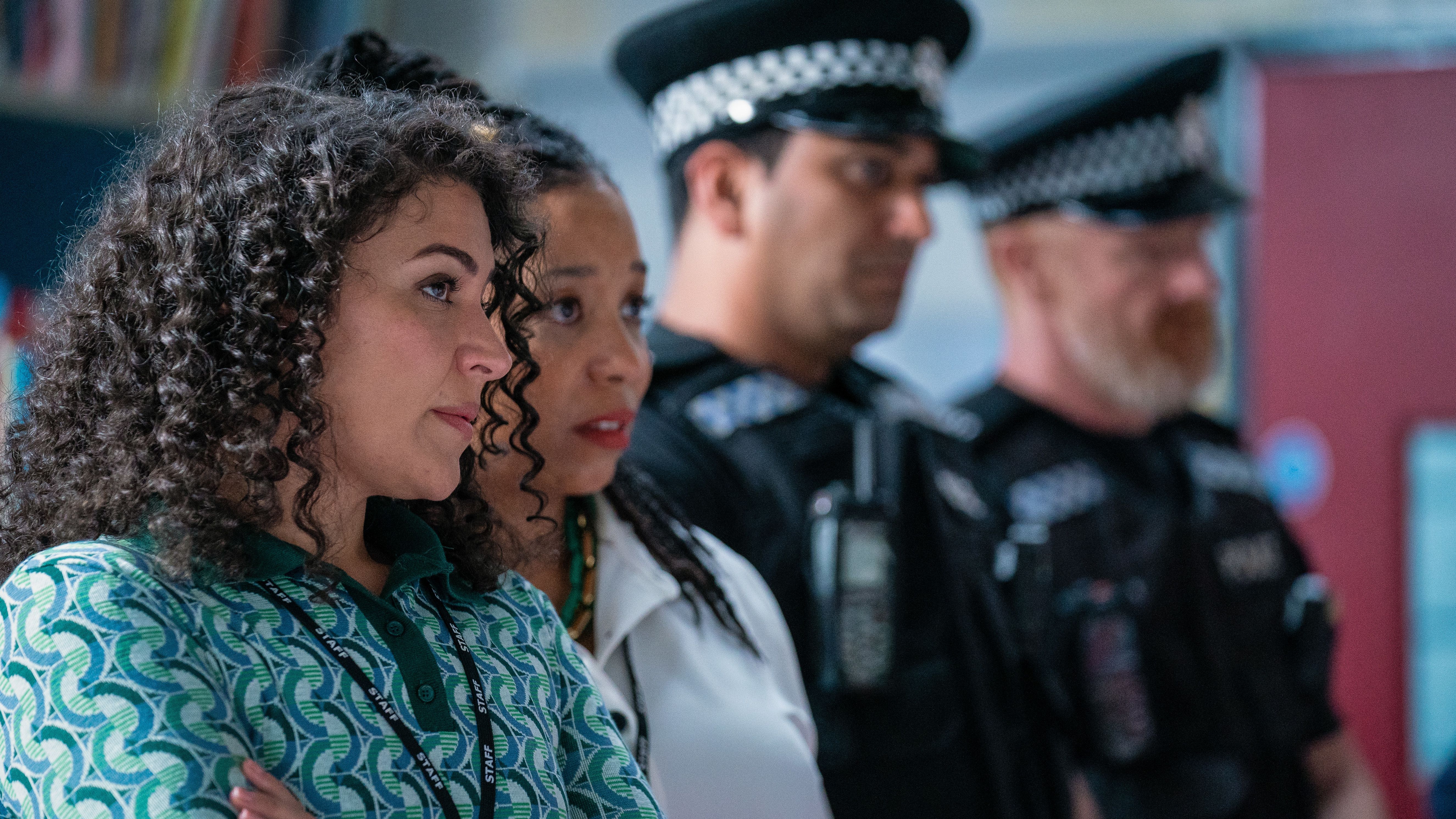 Jamiliah Omar (SONIA IBRAHIM) & Valerine Chambers (SHAUNA SHIM) stood next to police officers in Waterloo Road