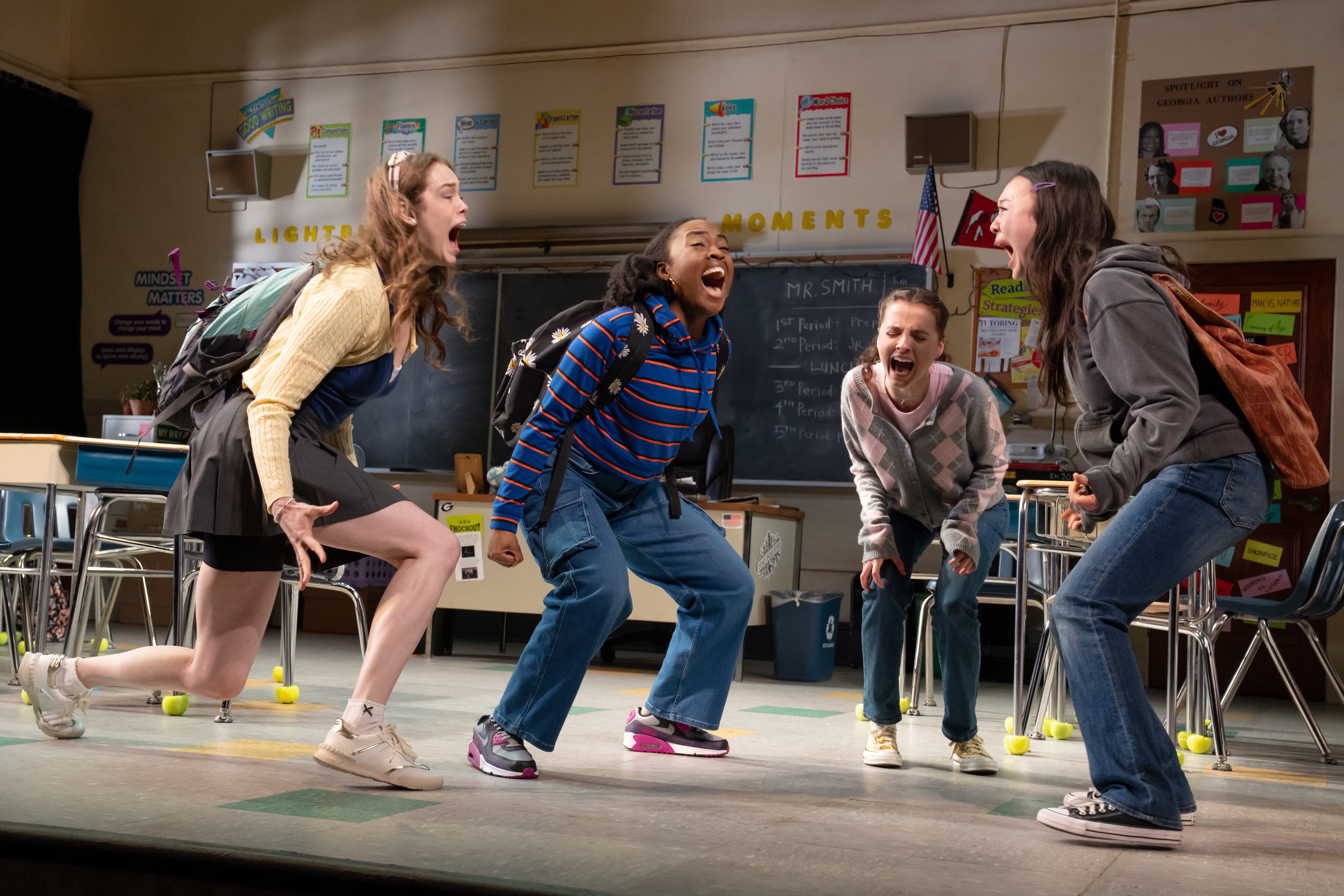 four teenage girls screaming in a classroom in the play john proctor is the villain