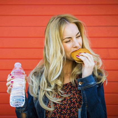 Woman Eating Cheeseburger