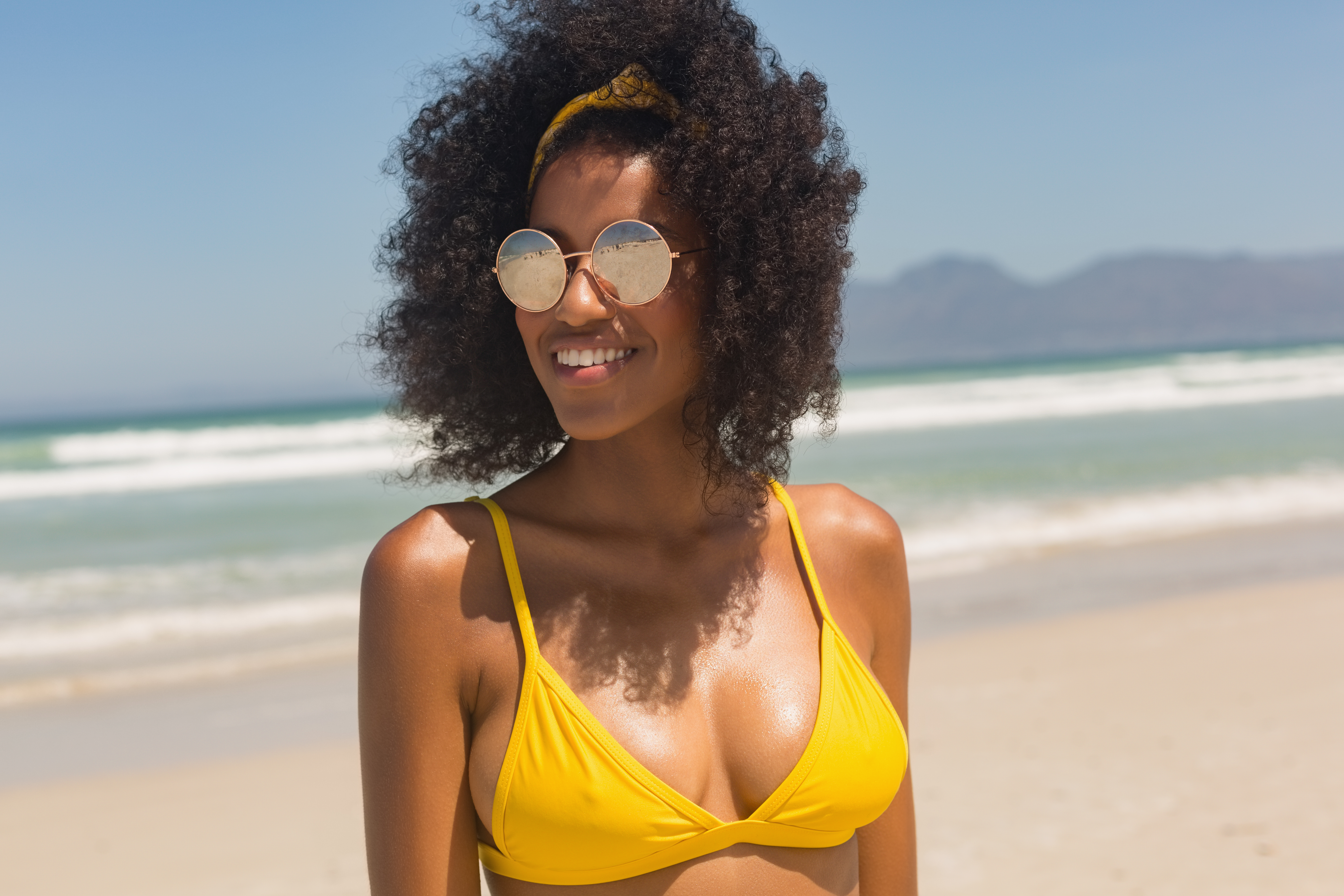 woman in a yellow bikini with sunglasses