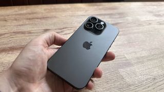 iPhone 15 Pro with a titanium finish running iOS 17