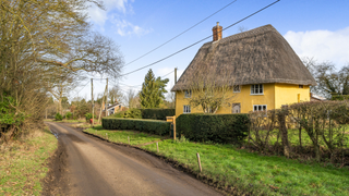 Grade II 16th century yellow thatched cottage in Suffolk.