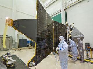 Bunny-suited technicians tend the Mars Atmosphere and Volatile Evolution mission (MAVEN) spacecraft at Lockheed Martin.