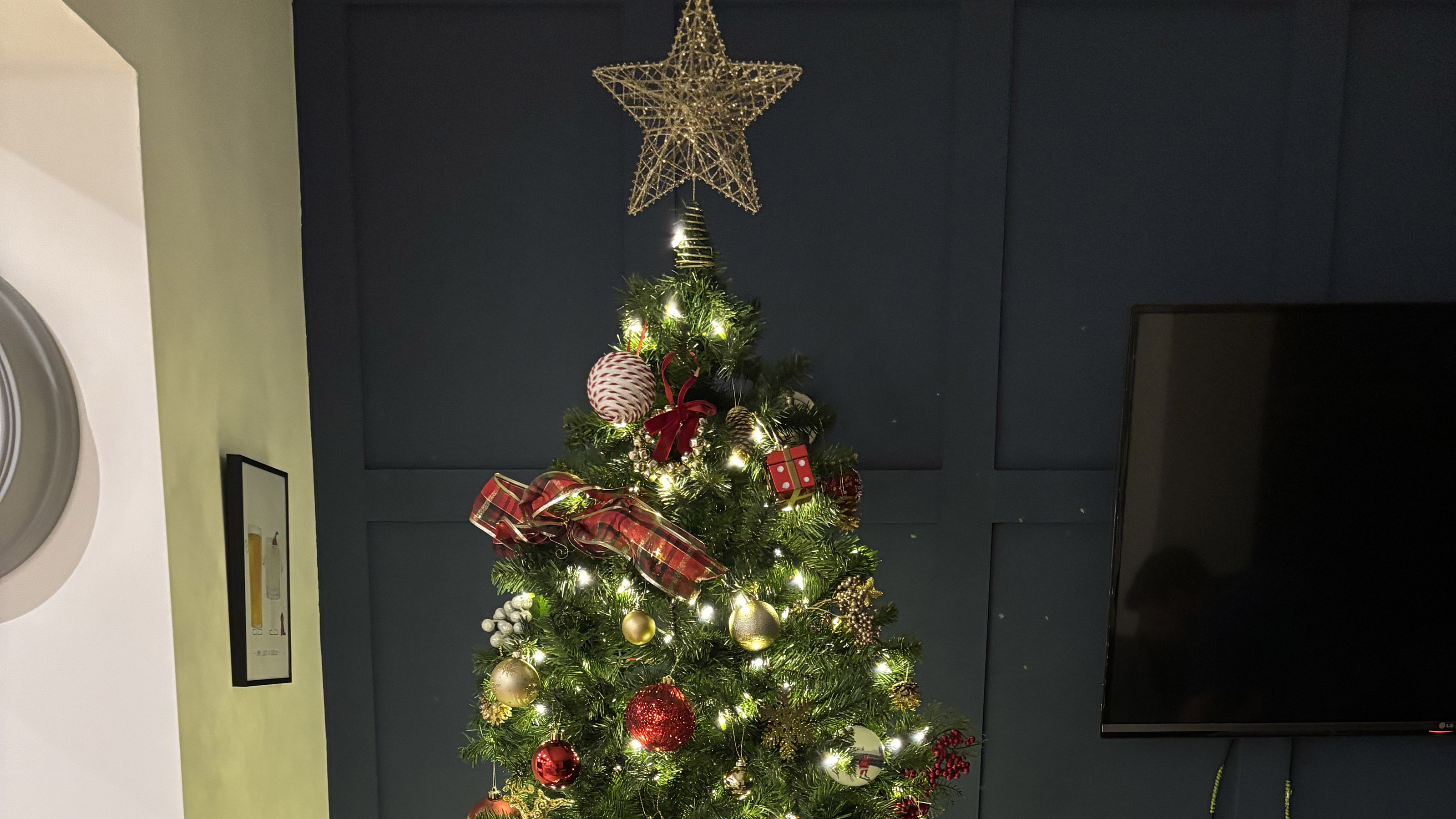 christmas tree with red and gold decorations and a star on the top