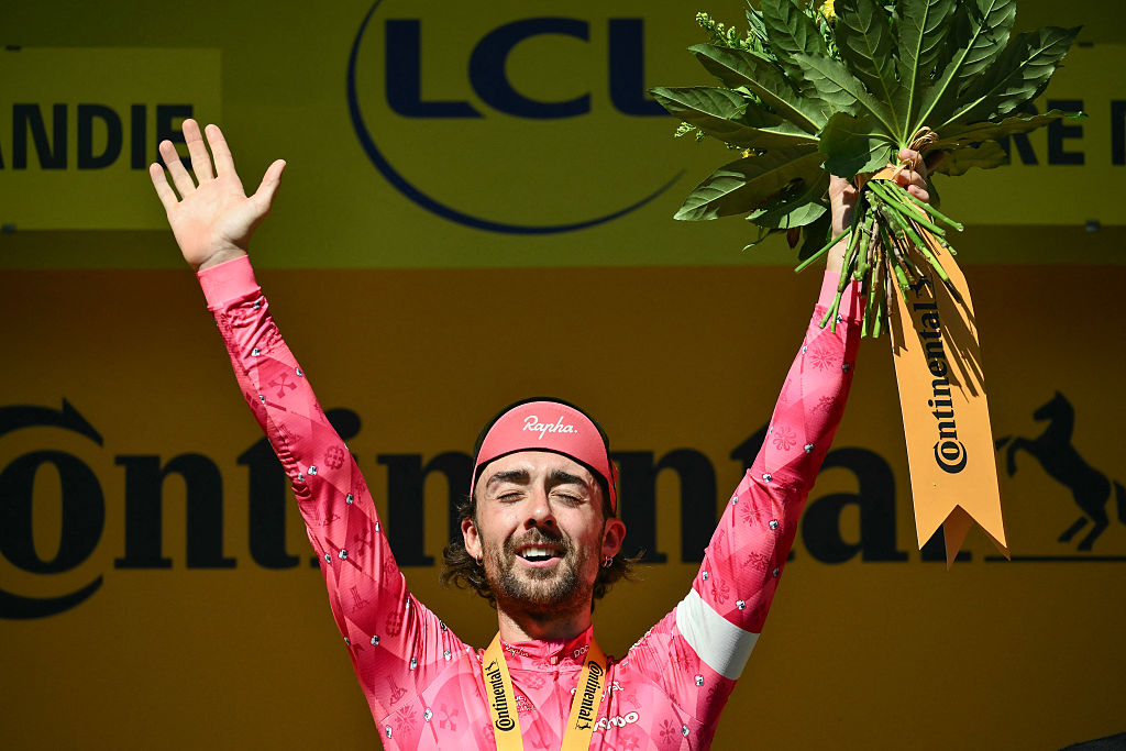 EF Education - EasyPost team's Irish rider Ben Healy celebrates on the podium after winning the 6th stage of the 112th edition of the Tour de France cycling race, 201.5 km between Bayeux and Vire Normandie, Northwestern France, on July 10, 2025. (Photo by Marco BERTORELLO / AFP)