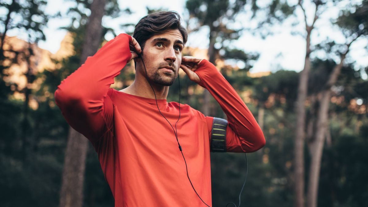 Man putting in headphones before run