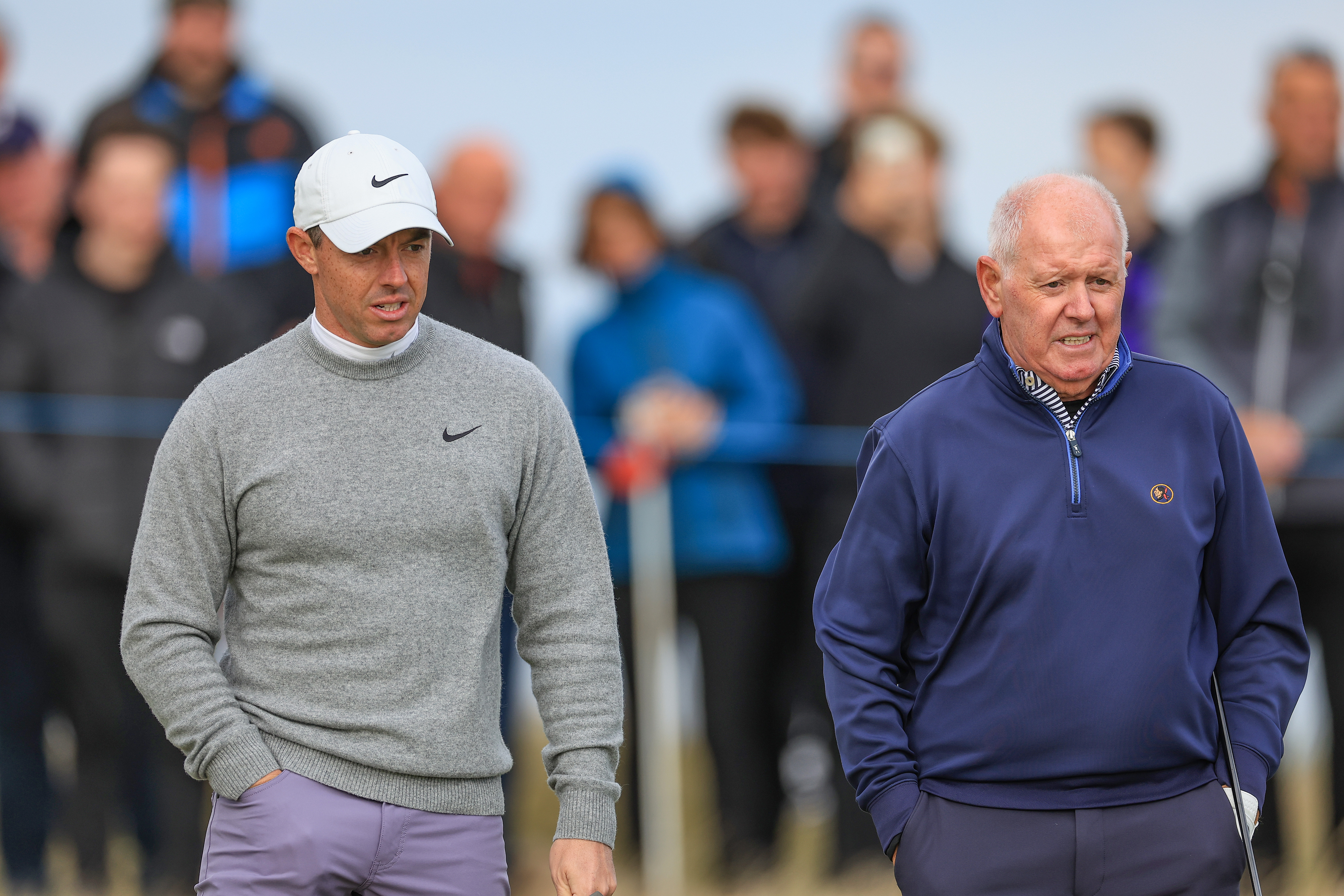 ST ANDREWS, SCOTLAND - OCTOBER 04: Rory McIlroy of Northern Ireland and his father Gerry McIlroy of Northern Ireland wait to putt on the first hole on day two of the Alfred Dunhill Links Championship 2024 at Kingsbarns Golf Club on October 04, 2024 in Kingsbarns, Scotland. (Photo by David Cannon/Getty Images)