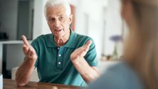 Senior man gestures while talking