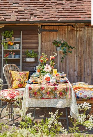 rustic outdoor dining ideas with floral tablecloth