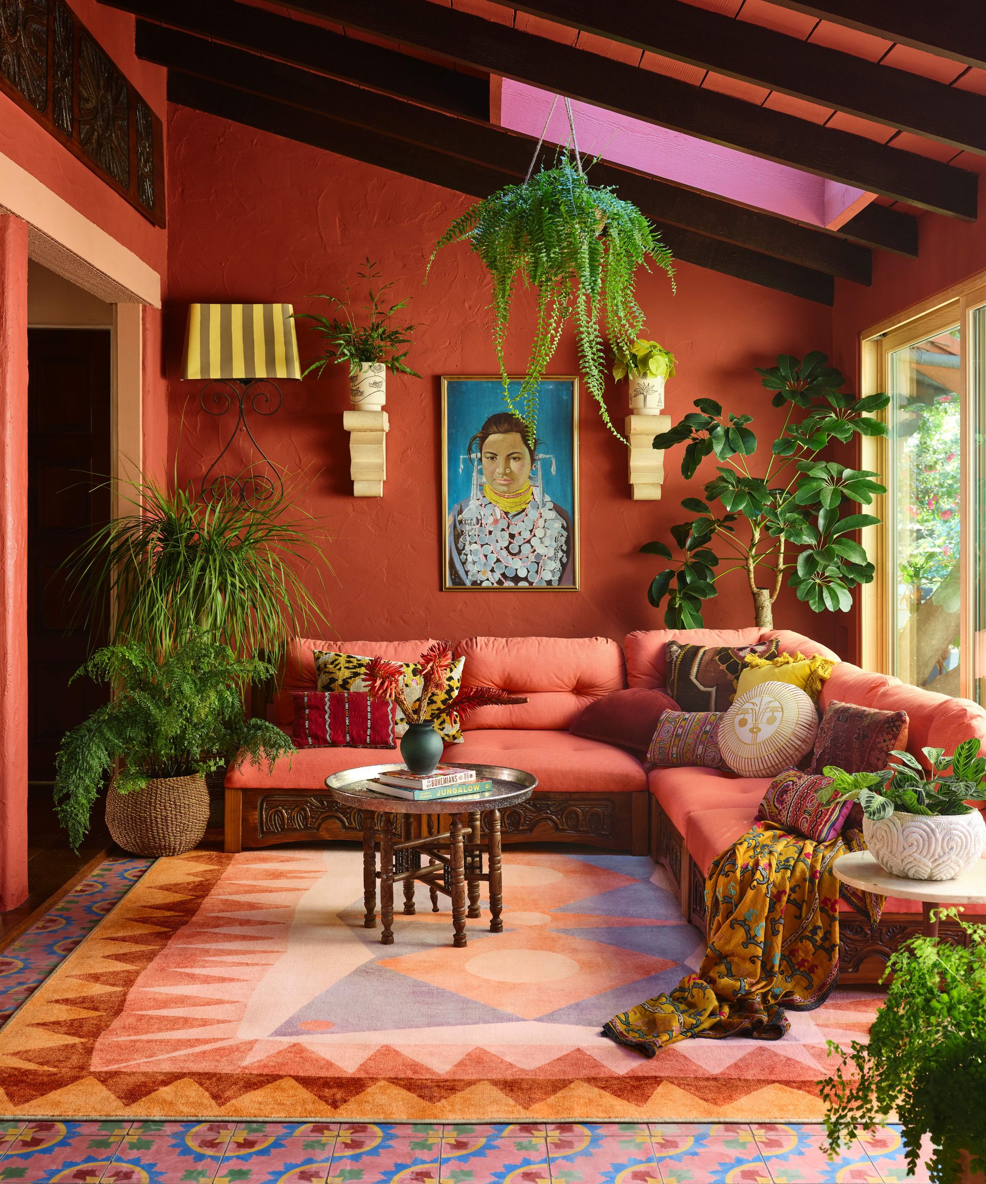 Red living room with a red corner sofas and house plants