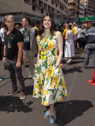 Alexandra Daddario wearing a yellow and white flower dress at the F1 Grand Prix of Monaco on May 26.