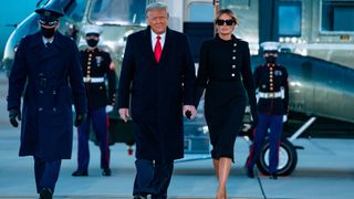TOPSHOT - Outgoing US President Donald Trump and First Lady Melania Trump step out of Marine One at Joint Base Andrews in Maryland on January 20, 2021. - President Trump and the First Lady travel to their Mar-a-Lago golf club residence in Palm Beach, Florida, and will not attend the inauguration for President-elect Joe Biden. (Photo by ALEX EDELMAN / AFP) (Photo by ALEX EDELMAN/AFP via Getty Images)