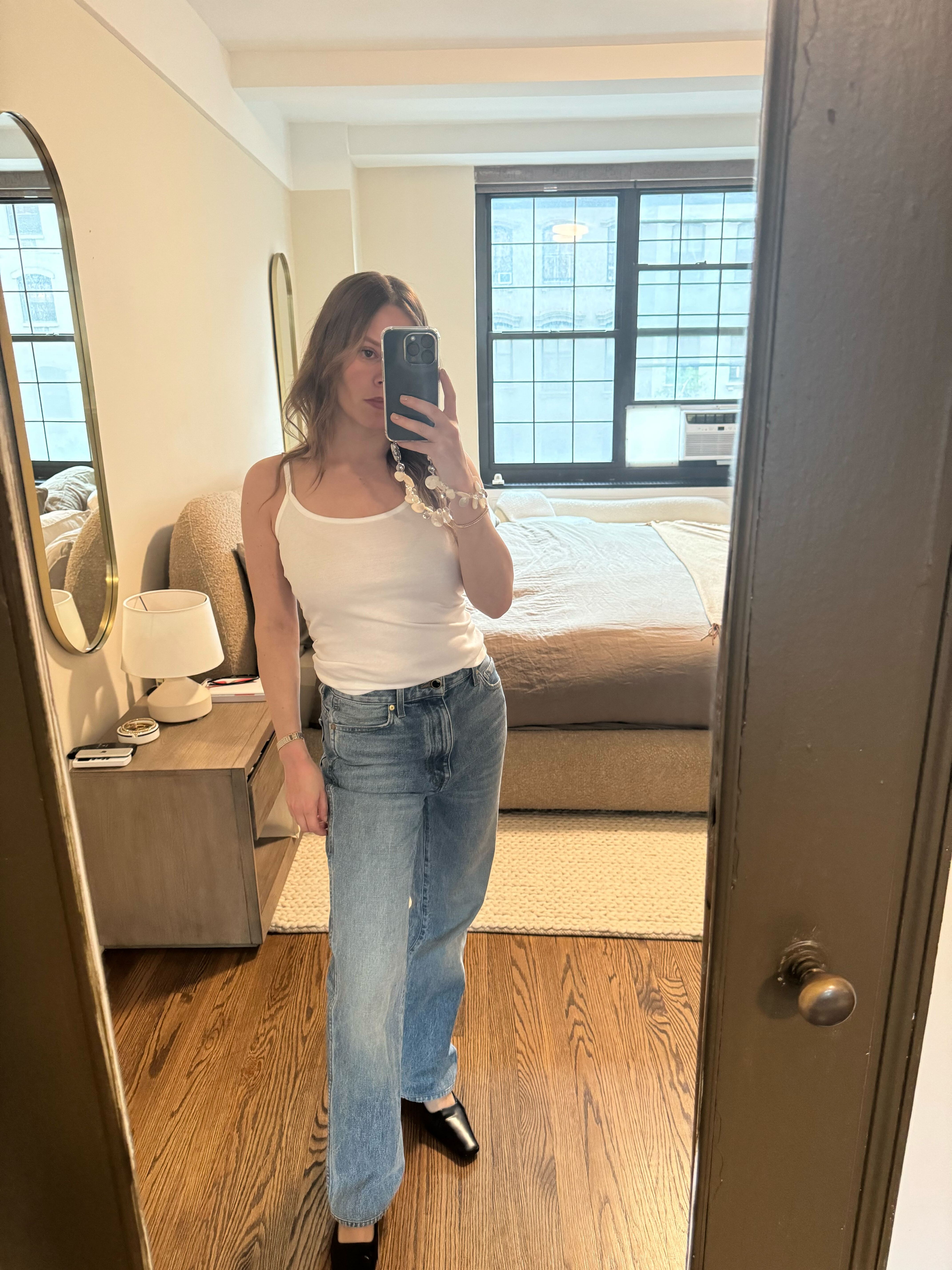 Nikki wore a white Bibi Cami top, blue jeans and a black pump.