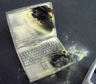 Burning Dell laptop. Notice all the fire extinguisher chemical.
