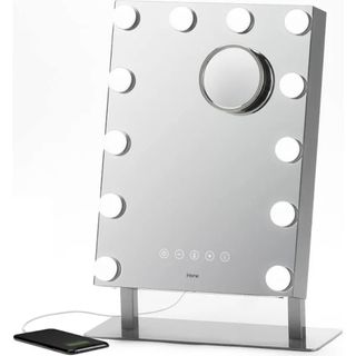 Lighted tabletop makeup mirror with magnifying component