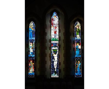 The three stained glass windows together that make up the East window, designed by the Pre-Raphaelite artist Edward Burne-Jones, at St James Church, Staveley, Cumbria.