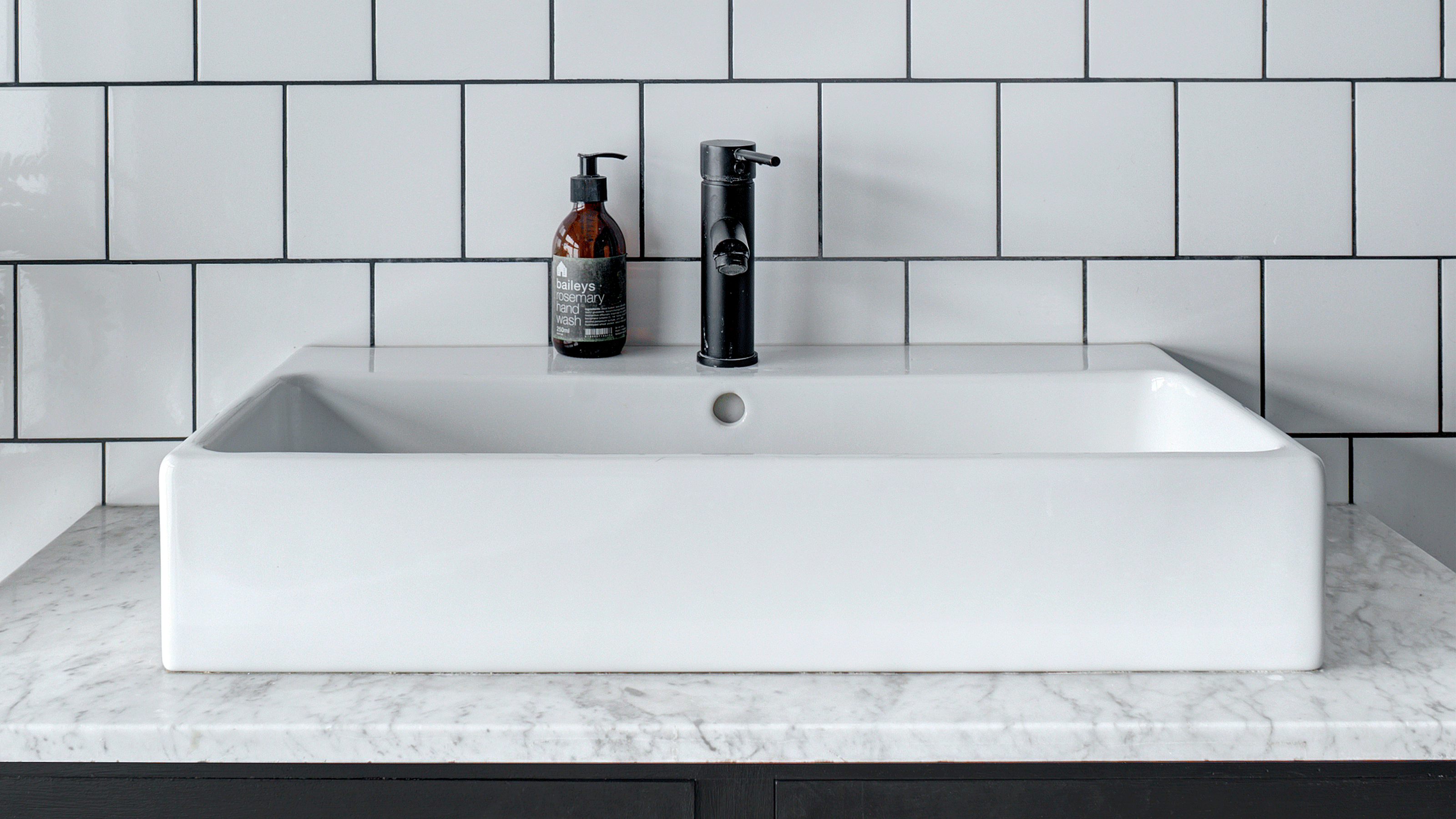 Brass bathroom mixer tap on a white basin