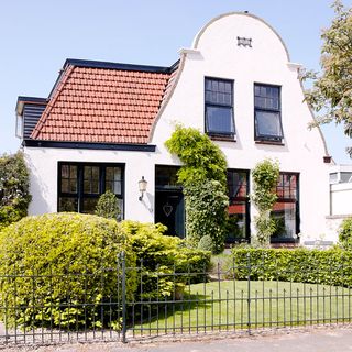 house with white wall and garden