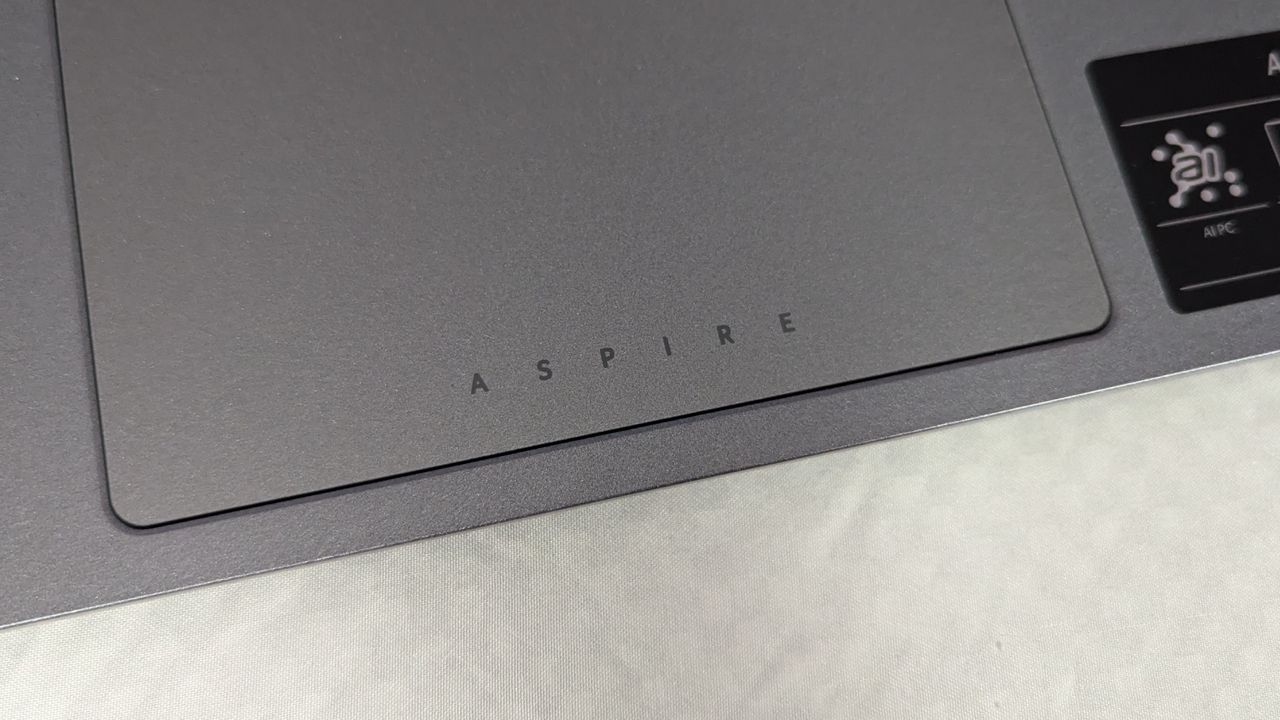 Top-down photo of the Acer Aspire 14 AI's touchpad badging against a white background.