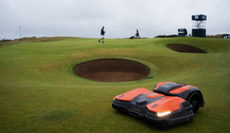 A robot mower next to a bunker