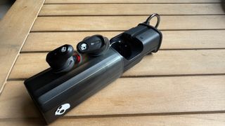 Skullcandy Method 360 ANC earbuds sitting on top of their case. 