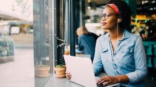 Woman listening to music on laptop