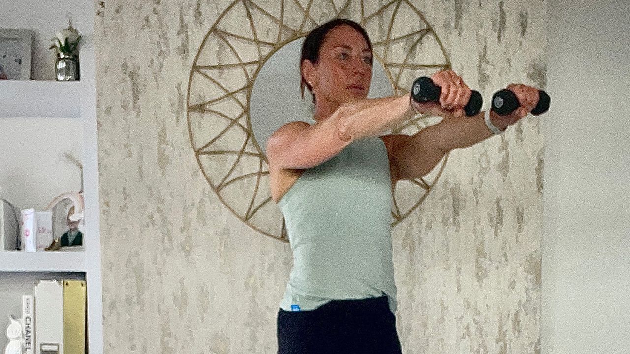 Lucy Miller performing V calf raises with a frontal raise using dumbbells
